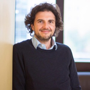 A portrait of David Sabatini wearing a blue sweater and a button-down.