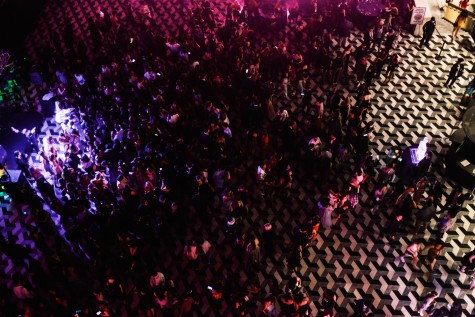 A bird’s-eye view of the Bobst atrium: a DJ and dance pool to the left; the entrance to Bobst and an ice sculpture to the right