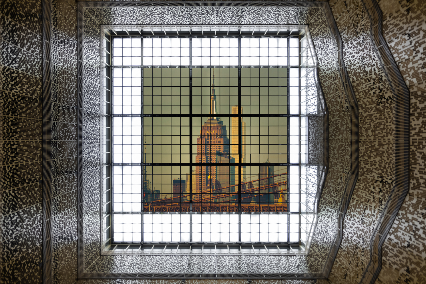 The ceiling of Bobst Library atrium overlaid with a picture of the Empire State Building.