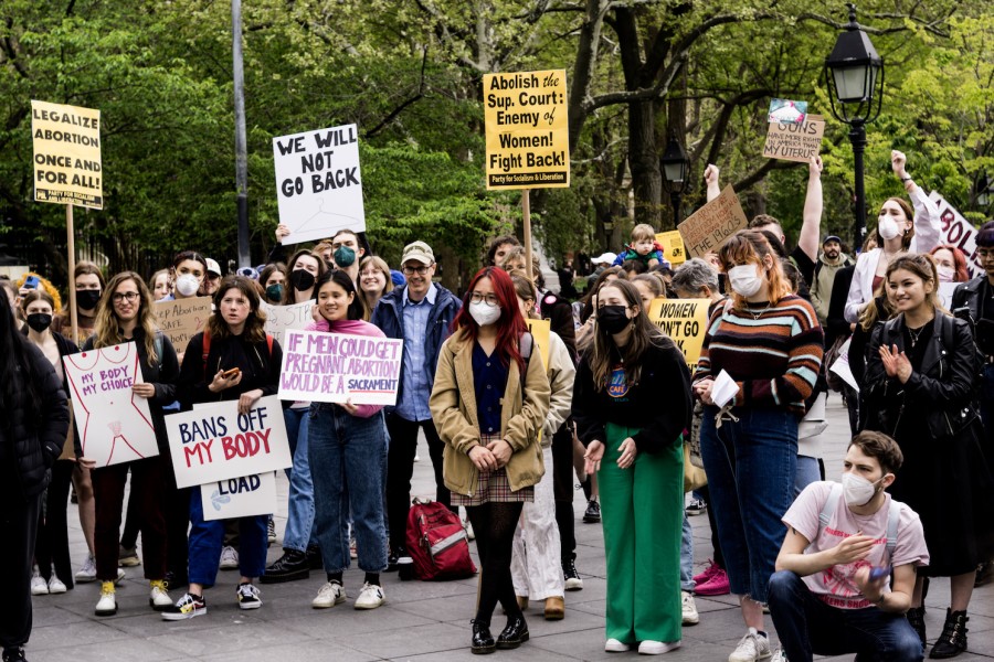 People hold signs at an abortion rights protest in Washington Square Park. Signs include "Legalize abortion once and for all," "We will not go back," and "My body my choice."