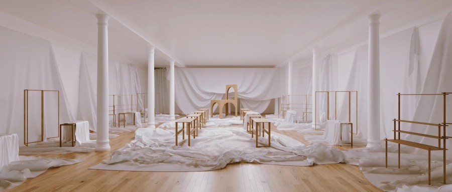A+view+of+a+white+room+with+white+pillars%2C+with+white+cloth+arranged+on+a+hardwood+floor.+Wooden+structures+can+be+seen+atop+the+white+cloth.