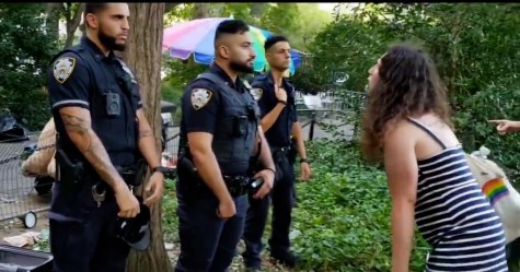 A woman shouts at three New York City Police Department officers.