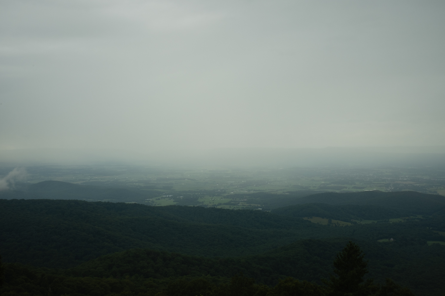 A foggy sky seen from atop a mountain.