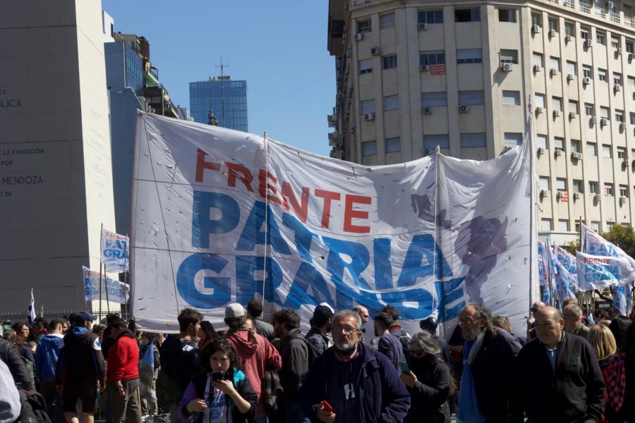 A crowd of protesters on the streets of Buenos Aires with the Obelisk to the left.