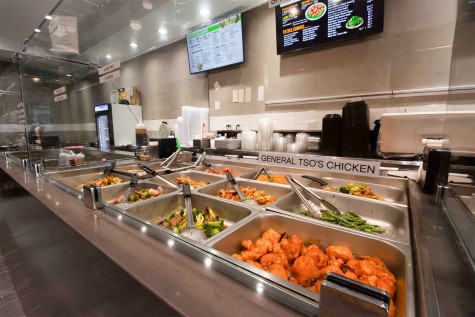 An assortment of asian cuisines lies in separate buckets behind the counter.