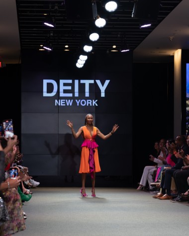Designer Renee Bishop steps onto the runway to thank the audience.