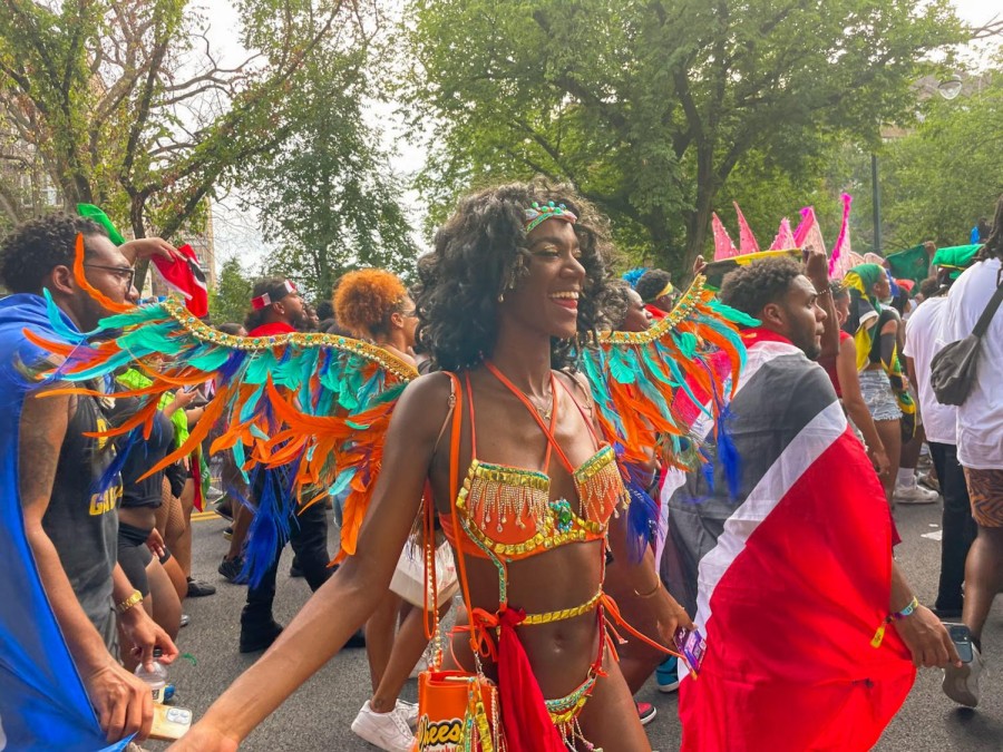 A+parade+participant+dressed+in+a+traditional+Caribbean+outfit.