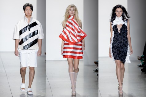A male model wearing a pair of white sandals walks in black-and-white zip-up jacket and a pair of white shorts; A female model wearing white heels walks in a red-and-white striped dress; A female model wearing white heels walks in a black furry dress with a white furry collar.