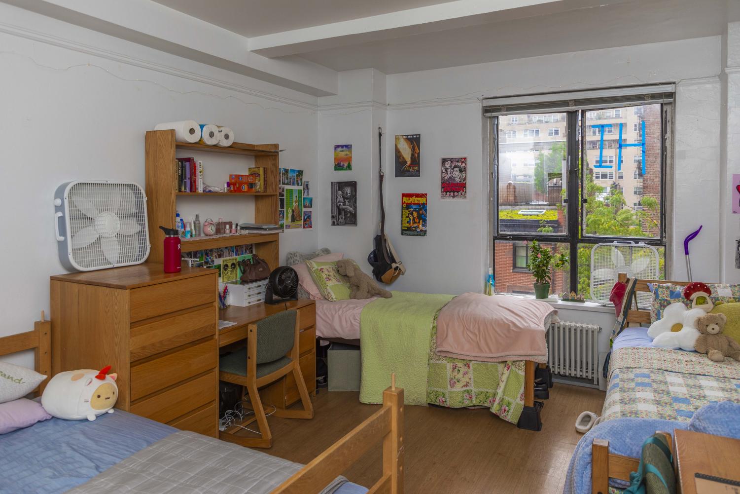 Catherine Desciak, Daisy Brookman and Sophia Wang’s dorm room has three twin beds with accompanying dressers and desks. The room is well decorated with various posters on the walls and small decor items throughout.