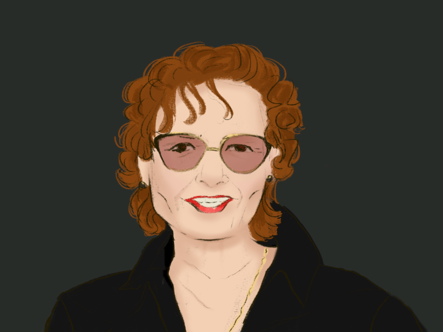 A portrait of Vivien Goldman wearing gold sunglasses and a black jacket.