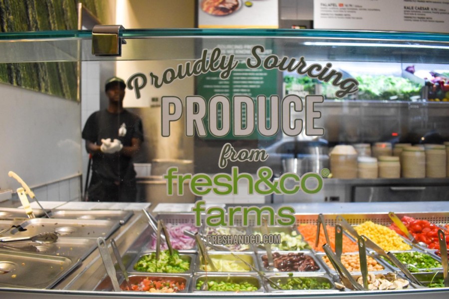 A counter with text on the window in front of an assortment of ingredients.