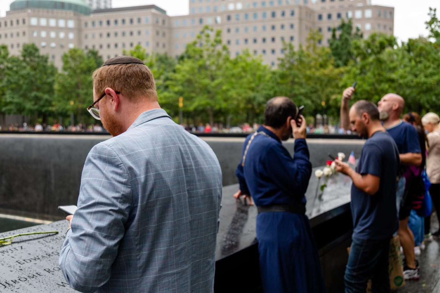 Visitors surround the Sept. 11 memorial pools.