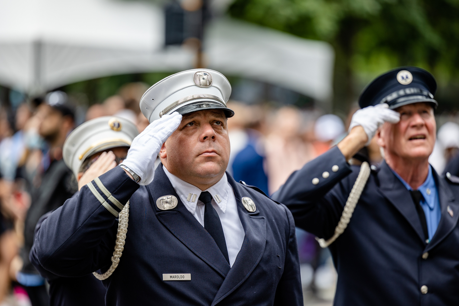 Officer Maroldo salutes to the memorial dressed in a navy uniform, white hat and white gloves.