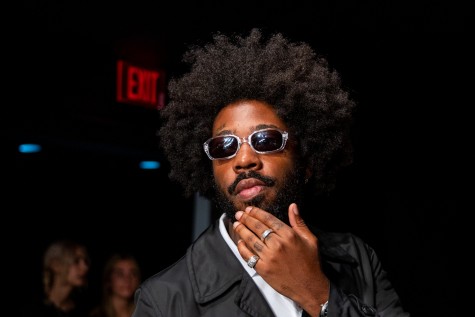 A portrait of Brent Faiyaz at anOnlyChild’s New York Fashion Week show. He is wearing sunglasses and is posing with his hand on his chin.