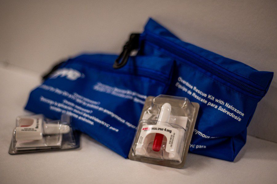 Two blue N.Y.C. Emergency Rescue Kit bags with two packages of 4mg Narcan Nasal Spray in front.
