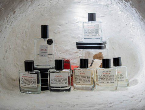 Eight bottles of perfume inside a white cave.