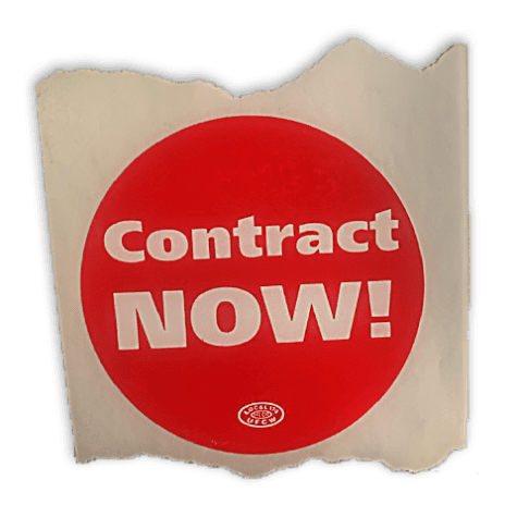 A photo of a fragment of paper with a circular red sticker printed on it. The text on the sticker reads “Contract NOW!”