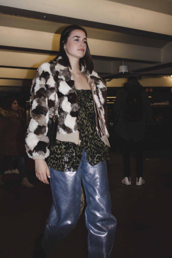 Let's talk about a staple for the winter: a faux-fur jacket. This fluffy jacket with a classic black, brown and white pattern is bound to turn heads. By pairing the piece with a pair of glittery baby blue pants and an animal print olive green top, the modern fit suddenly gives off a `90s vintage touch.