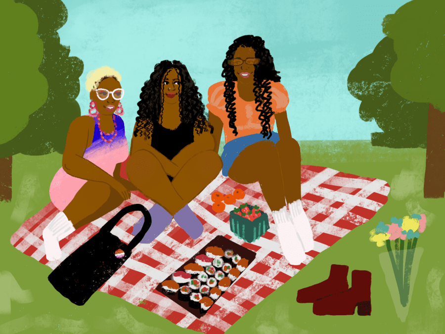 Three people sit on a red-and-white plaid picnic blanket in the middle of a meadow with trees on both sides. On the ground are a bouquet of pink, yellow and blue flowers, a pair of brown boots, a bowl of strawberries, a plate of sushi and a black tote bag. From left to right, a person with golden hair wears a pair of white glasses and a dress with blue and pink gradients. The person in the middle with long black curly hair wears a black dress. The person on the left with long black curly hair wears a pair of orange tinted glasses, an orange shirt and a blue bottom.