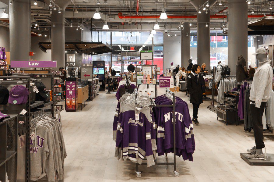 Store interior with stacks of clothes and a mannequin on the right.  The clothes are mostly purple, some of them have 