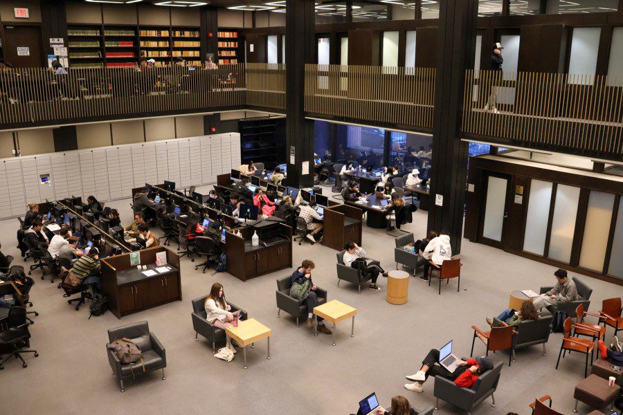 Students+studying+inside+N.Y.U.%E2%80%99s+Bobst+Library+in+a+large+room+on+the+ground+floor.+Several+rows+of+desks+with+computers+are+visible.