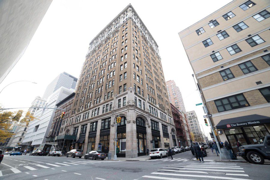 The exterior of N.Y.U. Lafayette Hall during the day from the diagonal corner of the street.