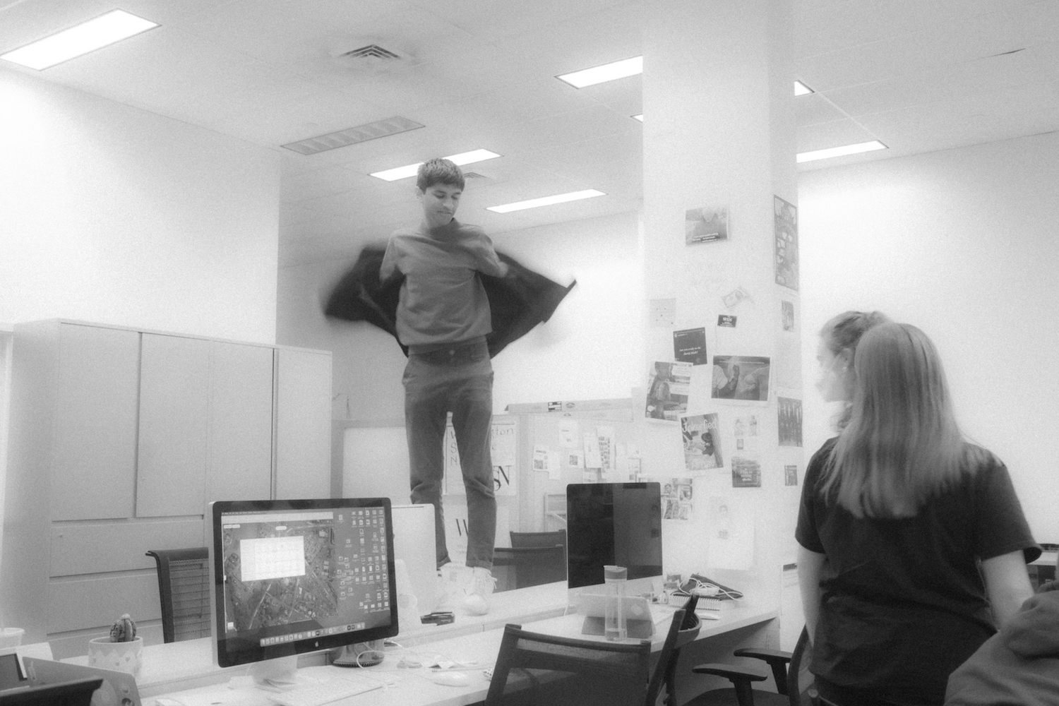 Arnav Binaykia tries to fly while standing on a desk.