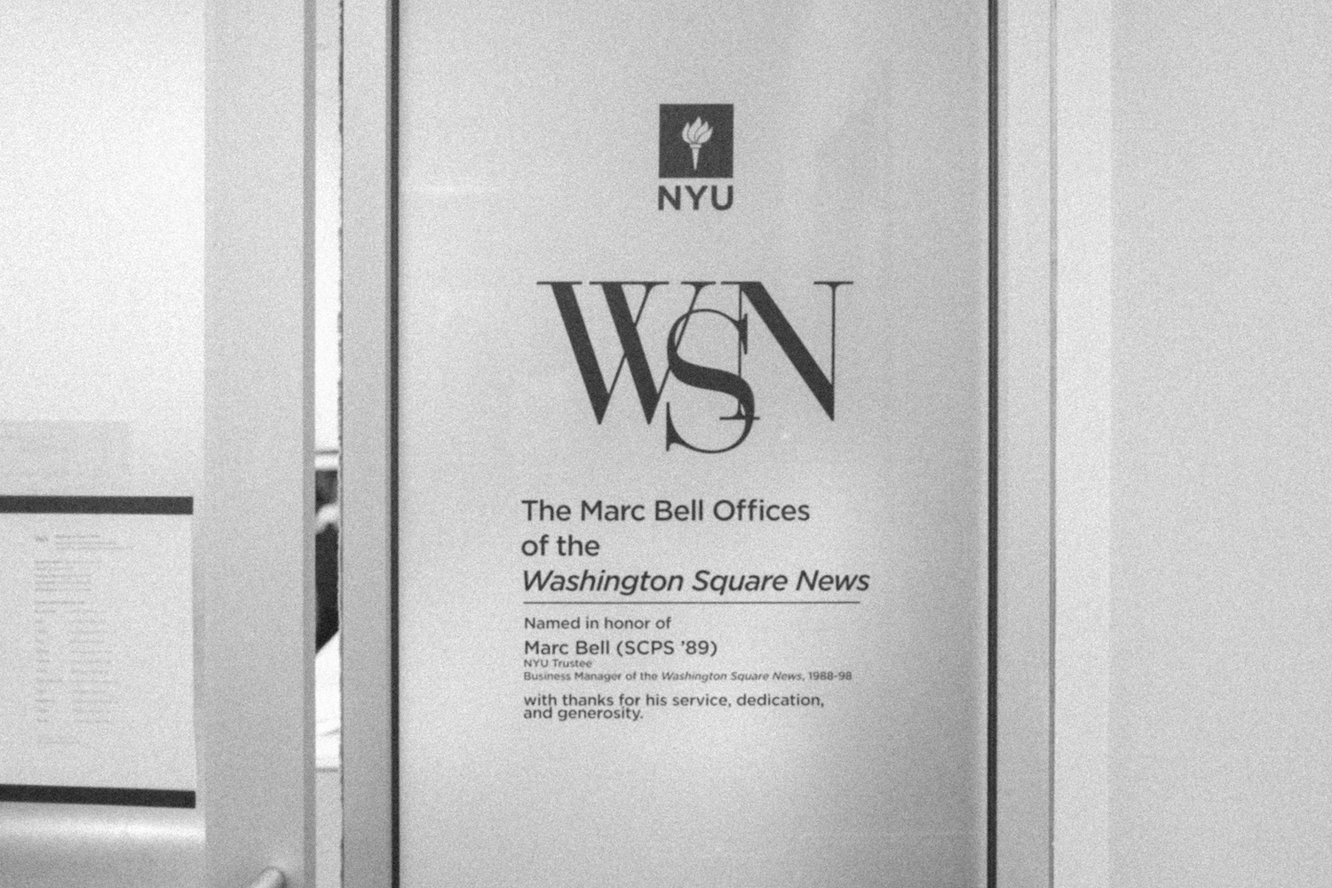 Words imprinted on the office front door that reads “N.Y.U. W.S.N. The Marc Bell Offices of the Washington Square News”