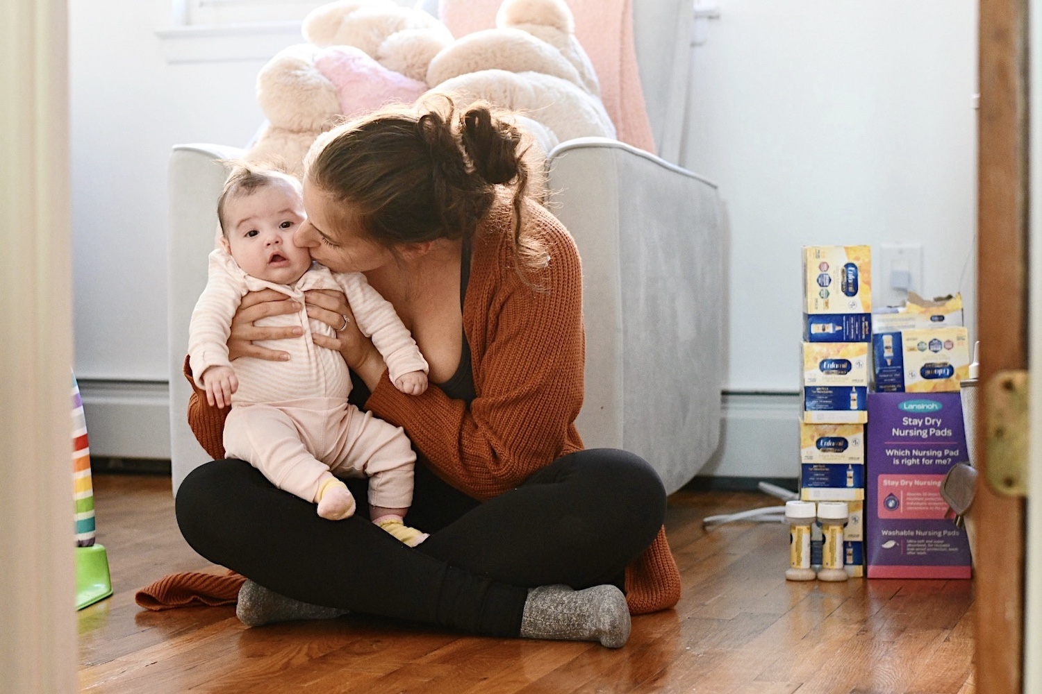 Nov. 18, 2022. Magi kisses Ava’s cheek on the floor of her nursery, next to a new supply of baby formula.