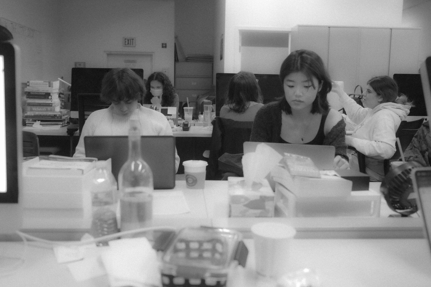 Nicolas Pedrero-Setzer and Stephanie Wong sit next to each other working on regular production.