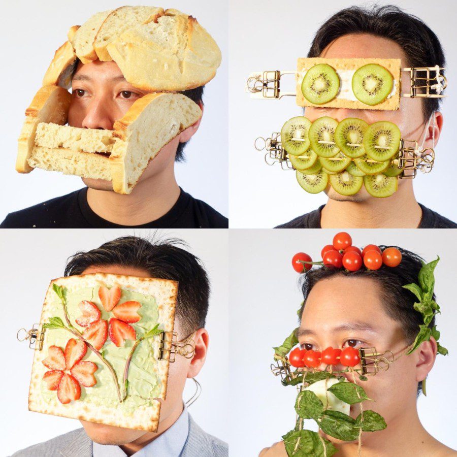 A collage of four photos. The top right features a man wearing a mask with kiwis covering the mouth region and a cracker with kiwis covering the eye region. The top left features a man wearing a food mask with multiple slices or bread surrounding the head, leaving the eyes visible. The bottom right features a man wearing a food mask with multiple tomatoes and basil leaves near the head and mouth regions. The bottom left features a man wearing a food mask with a giant cracker topped with strawberries, a leafy green and green paste on top.