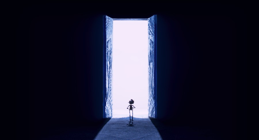 A silhouette of a puppet with a long nose walking through an open gate with a bright ray of light shining through it.