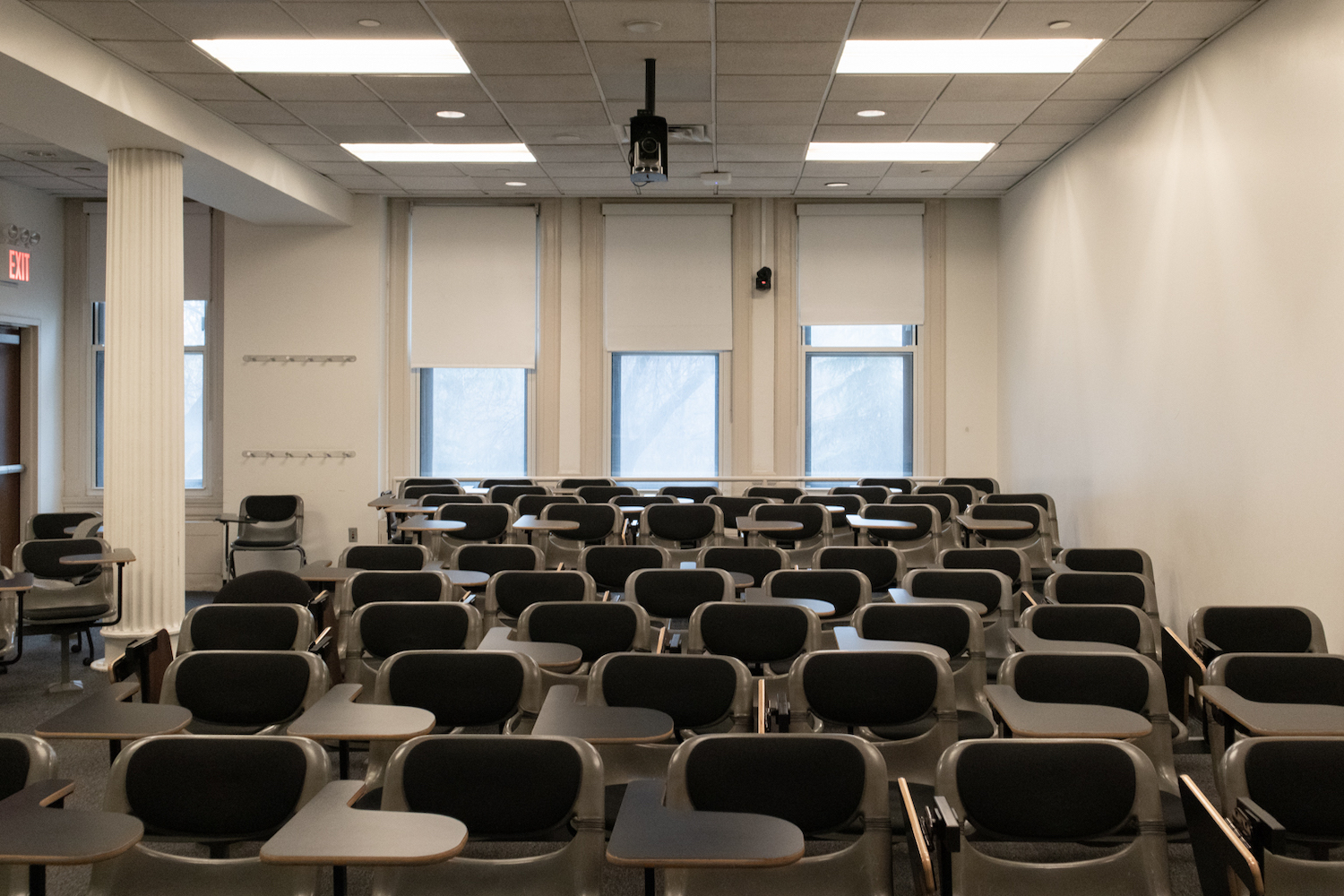 A photo of a classroom out of session, filled with unoccupied chairs.