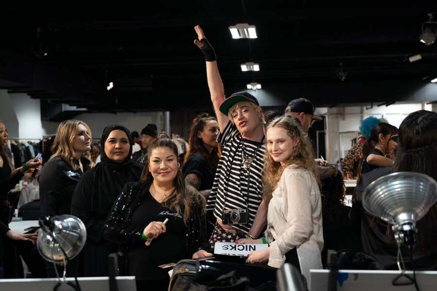 Group photo of designer Richie Rich, female model and two makeup artists.