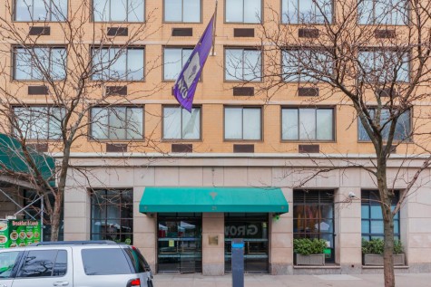 The exterior facade of Caryle Court is shown from across the street.