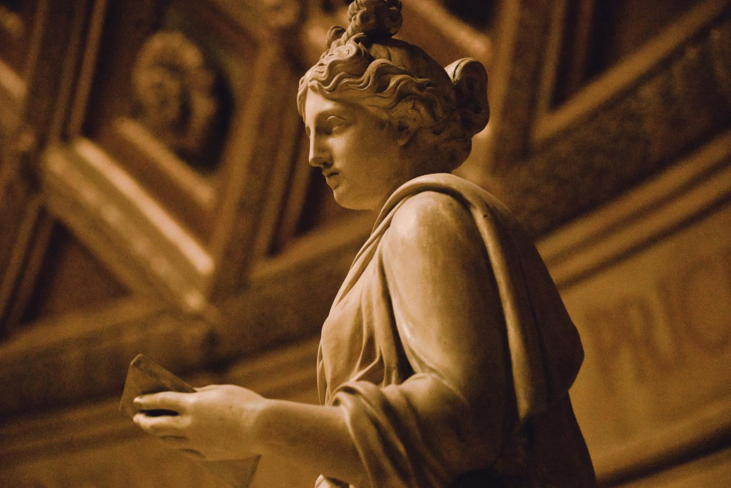 A greek statue atop the library rotunda.