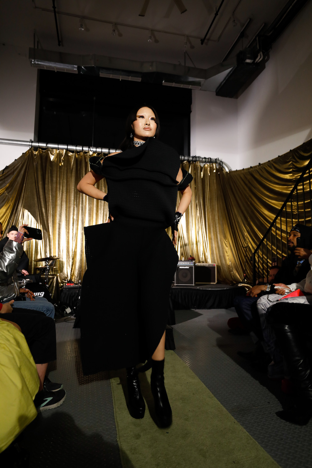 Model dressed in full black walking down the runway designed by collaborators Paradoxvestedrelics, Yxen, and Kids Destroy.