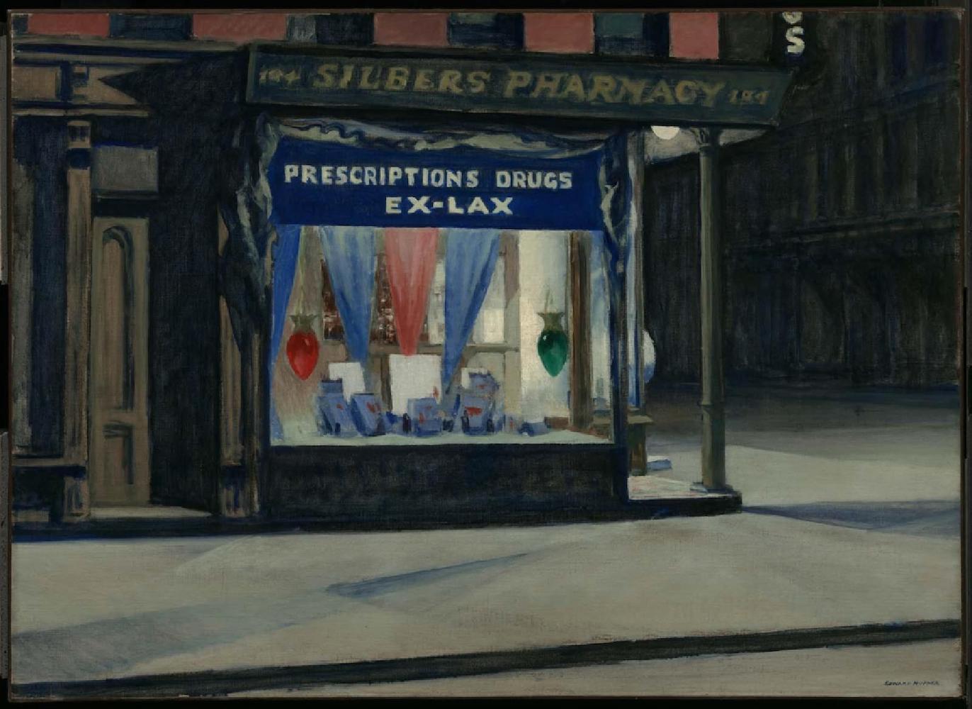 “A reproduction of a painting by Edward Hopper, which shows the facade of a drug store illuminated from within at night.”