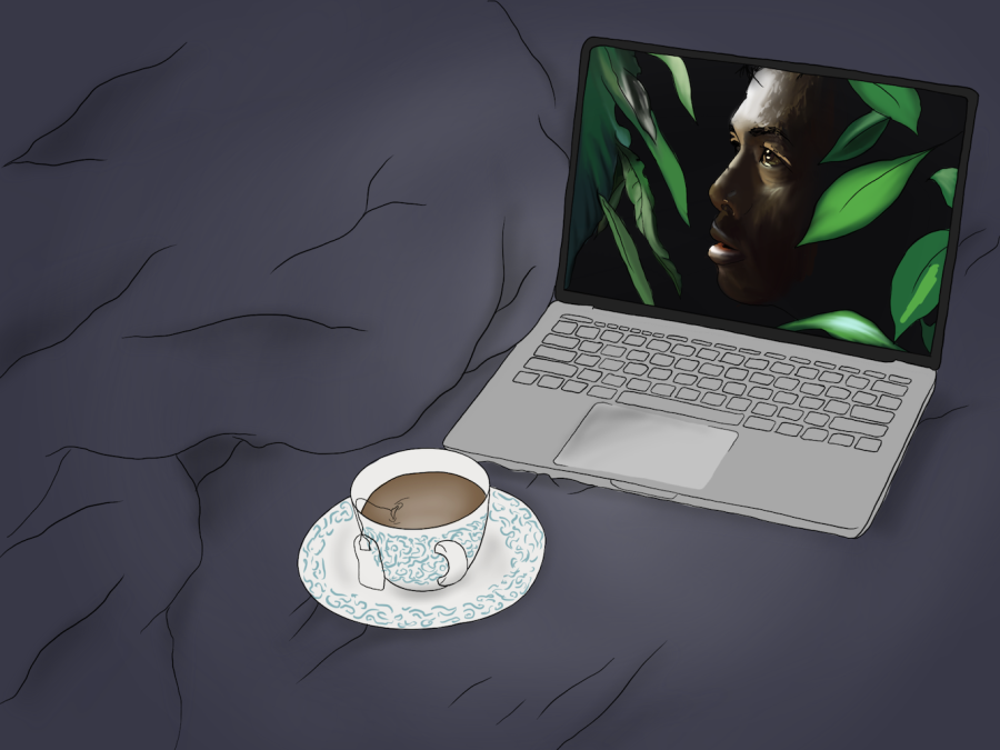 A dark blue bedsheet with a laptop on it showing a man’s face hidden between leaves on the screen. A white teacup with blue details and a tea bag draped over its side sits in front of the computer.