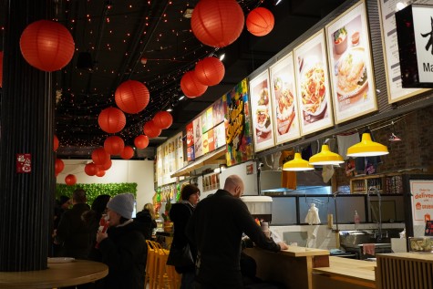 The interior of the Canal Street Market. Red lanterns are on the ceiling. On the right are menus displaying East Asian cuisine.