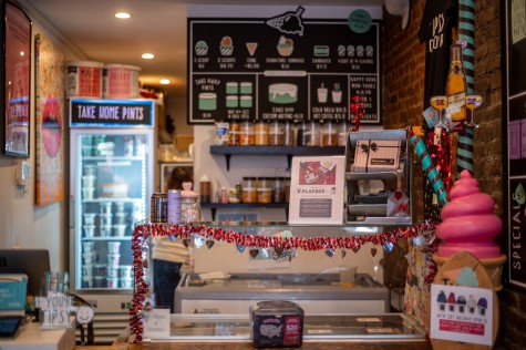 The interior of an ice cream shop with shiny, heart-shaped decorations. There is a scaled-up ice cream cone on the right side.