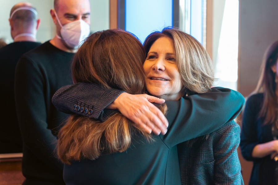 N.Y.U+president-designate+Linda+Mills+hugs+a+woman+wearing+a+black+suit.