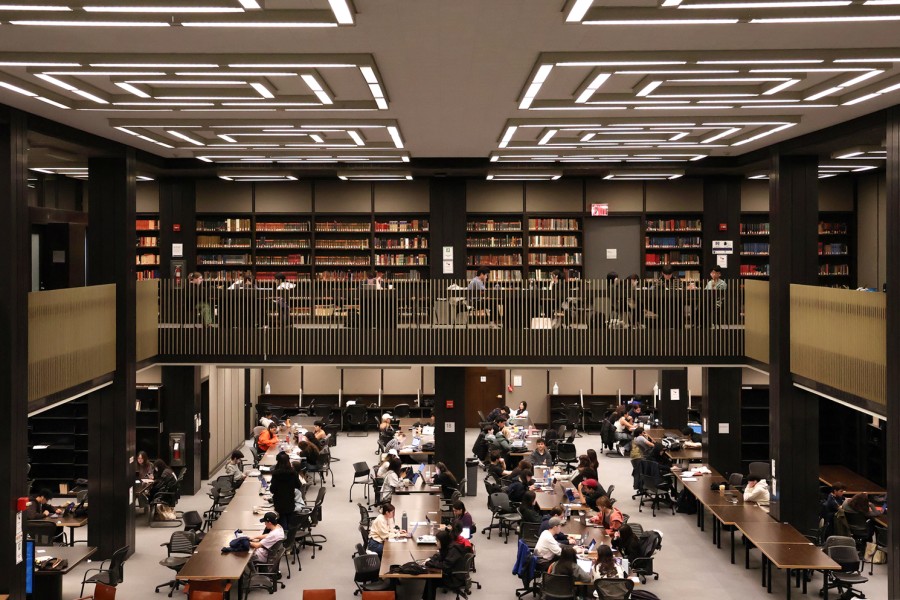 An+image+of+two+levels+of+Bobst+Library%2C+with+students+studying+at+tables+on+both+floors.