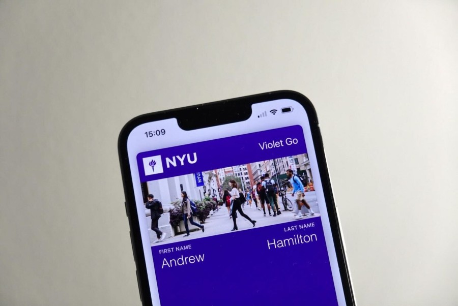 A smartphone displaying a pass inside of its digital wallet. The pass has a purple background with N.Y.U.’s logo and the text “Violet Go” on the top. The image indicates the pass belongs to a person named Andrew Hamilton.