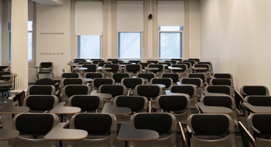 A photo of a classroom that is full of unoccupied chairs.
