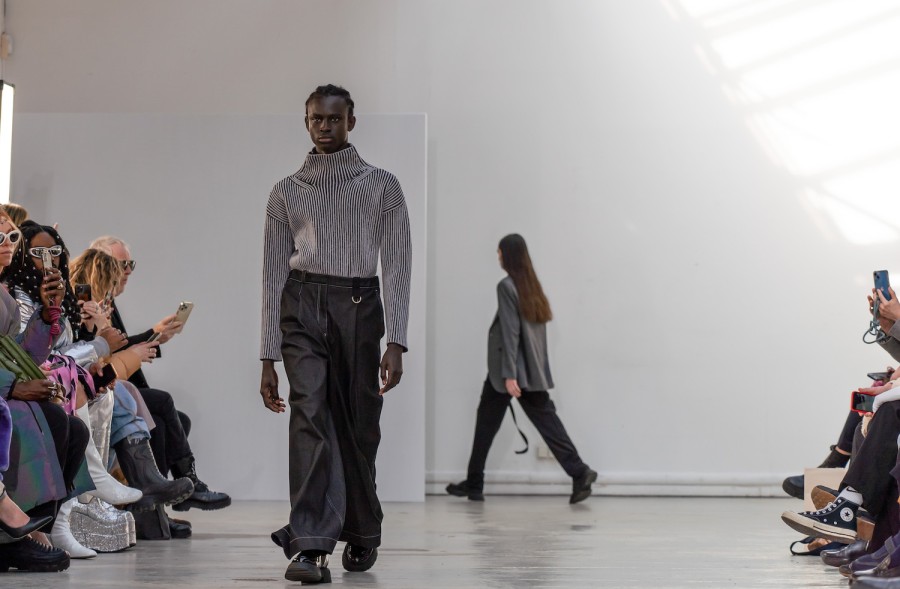 Baye walking in a striped black-and-white top with black pants at the Nehera fashion show.