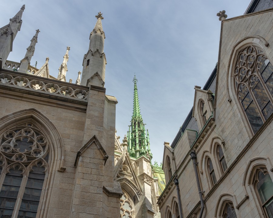 The green spire and marble buttresses of the Saint Patrick’s Cathedral.