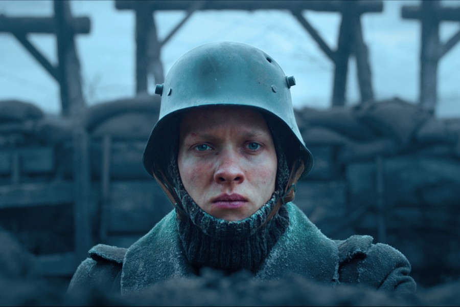 A+soldier+wearing+a+helmet+in+a+trench.