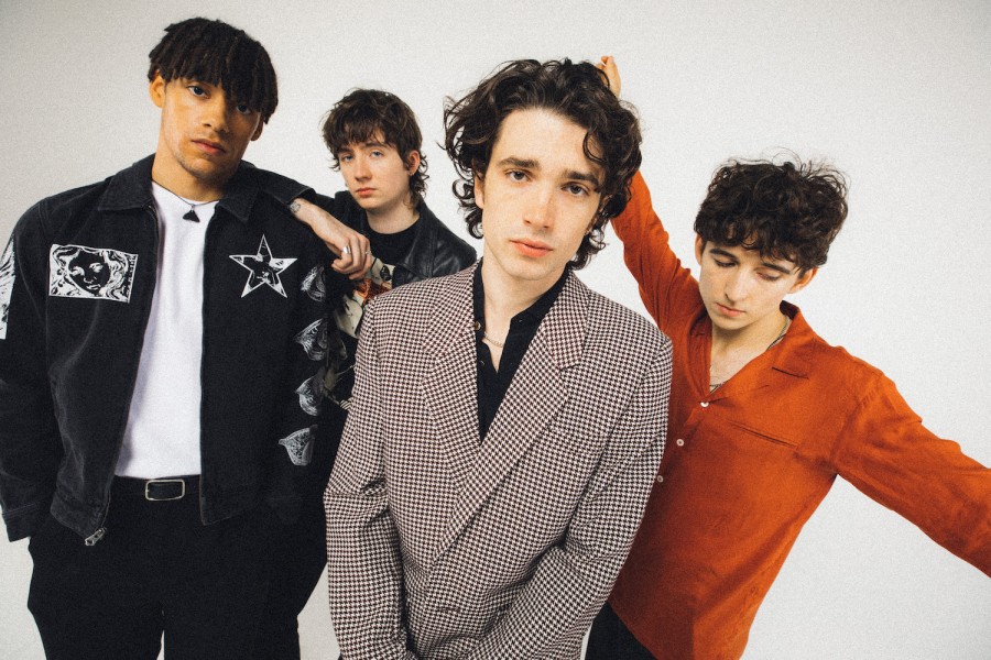 A photograph of the four members of the band “Inhaler,” standing together against a white screen.