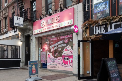 A storefront of an ice cream shop with a pink sign and the text “Sixteen Handles.” Stickers on the window show a pink cup of ice cream with eyes, arms and legs.